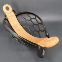 a wooden object with a black metal basket